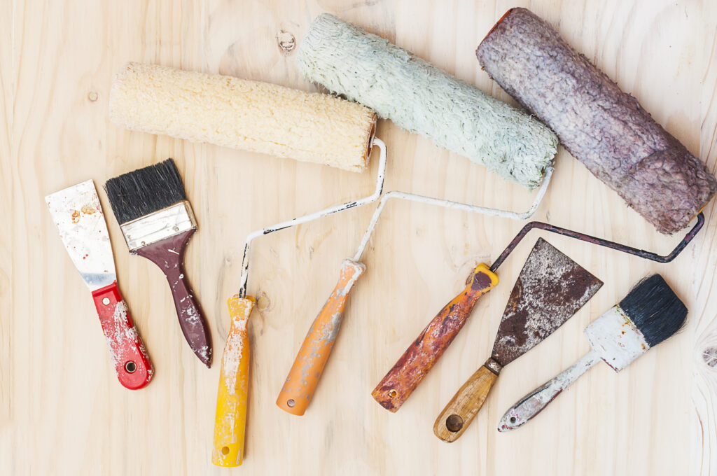 old painting brush set, hand tool, over white wooden background